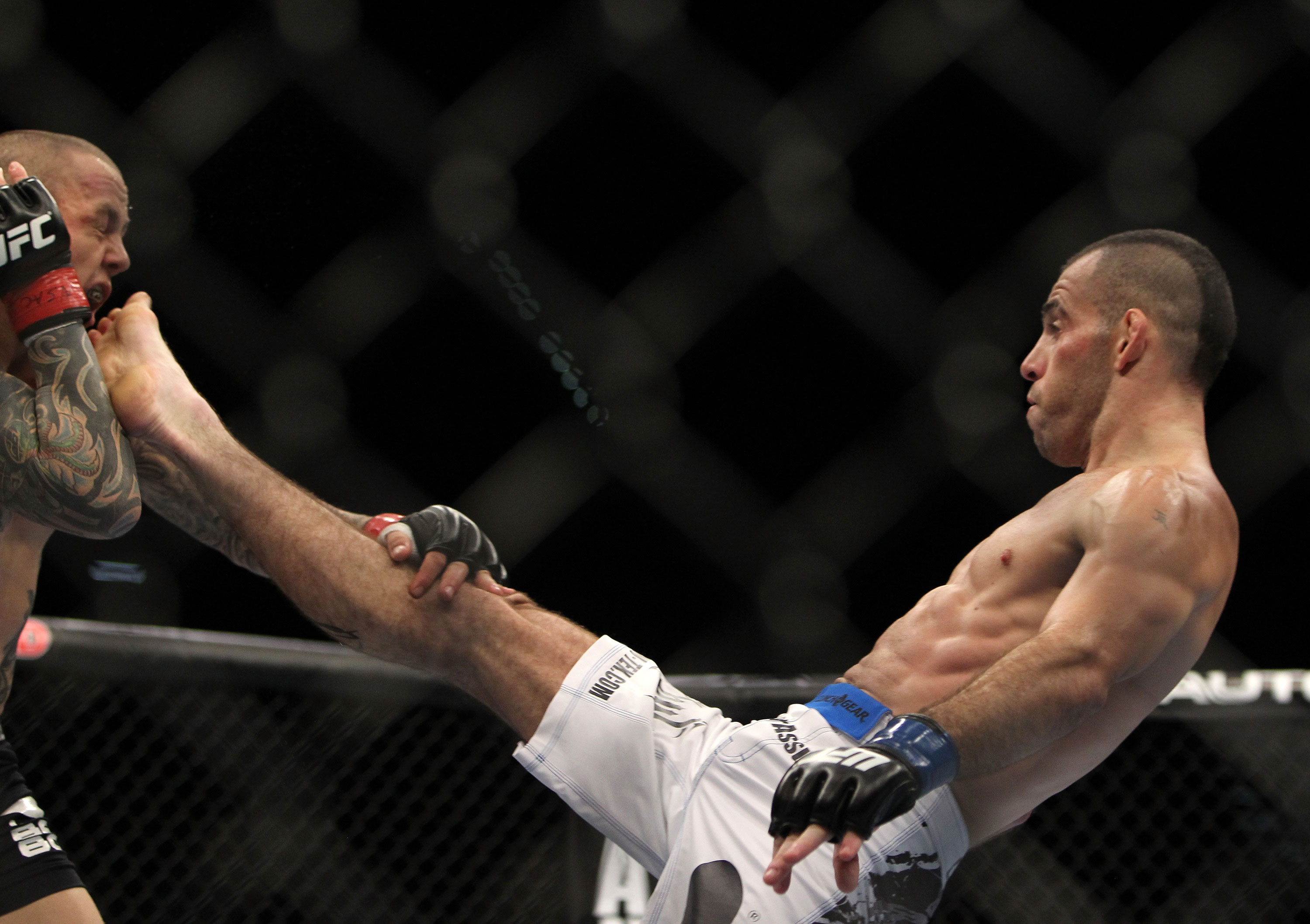 LAS VEGAS, NV - DECEMBER 30: Junior Assuncao (right) kicks Ross Pearson (left) during the UFC 141 event at the MGM Grand Garden Arena on December 30, 2011 in Las Vegas, Nevada. (Photo by Josh Hedges/Zuffa LLC/Zuffa LLC via Getty Images) *** Local Caption *** Junior Assuncao; Ross Pearson