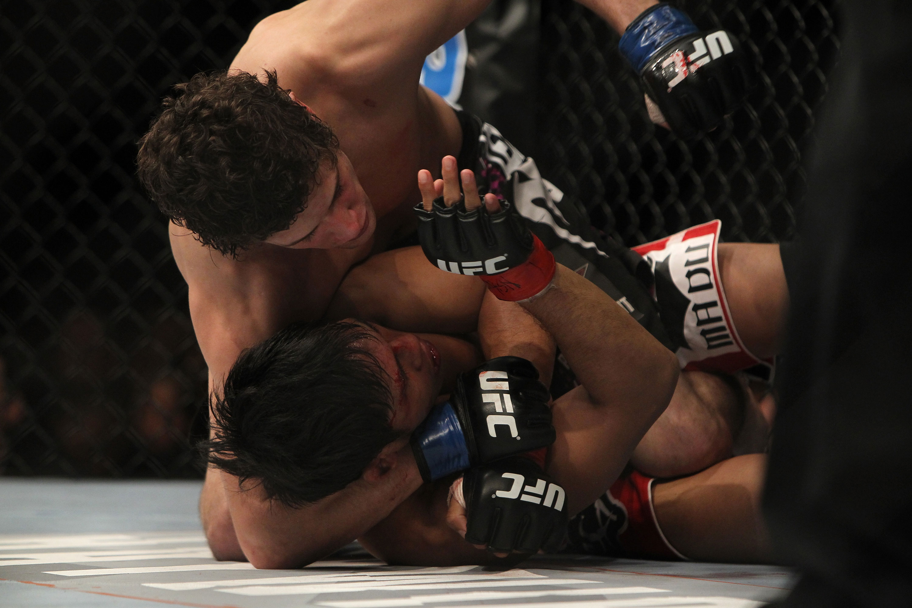LAS VEGAS, NV - DECEMBER 30: Jimy Hettes (top) punches Nam Phan during the UFC 141 event at the MGM Grand Garden Arena on December 30, 2011 in Las Vegas, Nevada. (Photo by Josh Hedges/Zuffa LLC/Zuffa LLC via Getty Images) *** Local Caption *** Jimy Hettes; Nam Phan