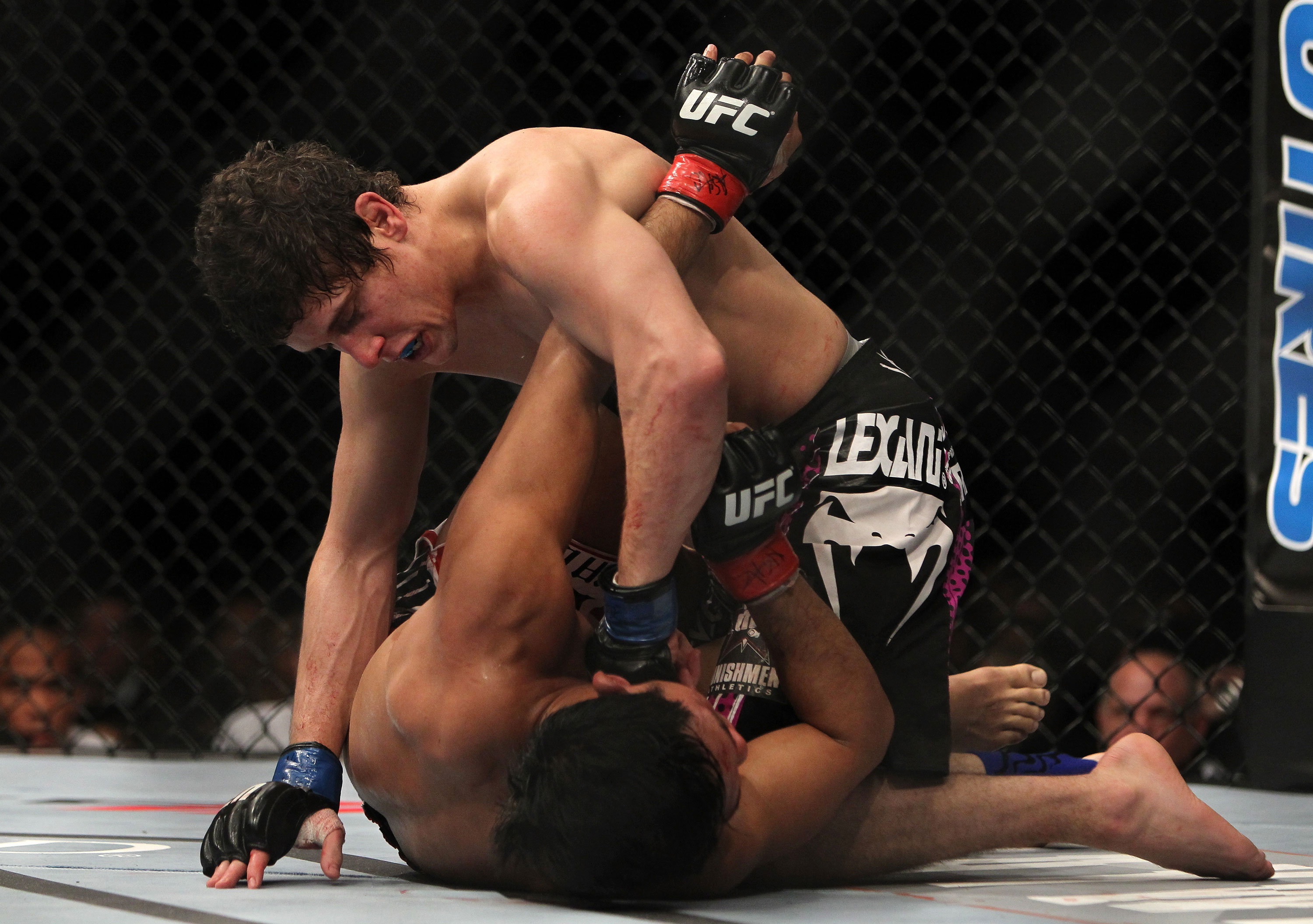 LAS VEGAS, NV - DECEMBER 30: Jimy Hettes (top) punches Nam Phan during the UFC 141 event at the MGM Grand Garden Arena on December 30, 2011 in Las Vegas, Nevada. (Photo by Josh Hedges/Zuffa LLC/Zuffa LLC via Getty Images) *** Local Caption *** Jimy Hettes; Nam Phan