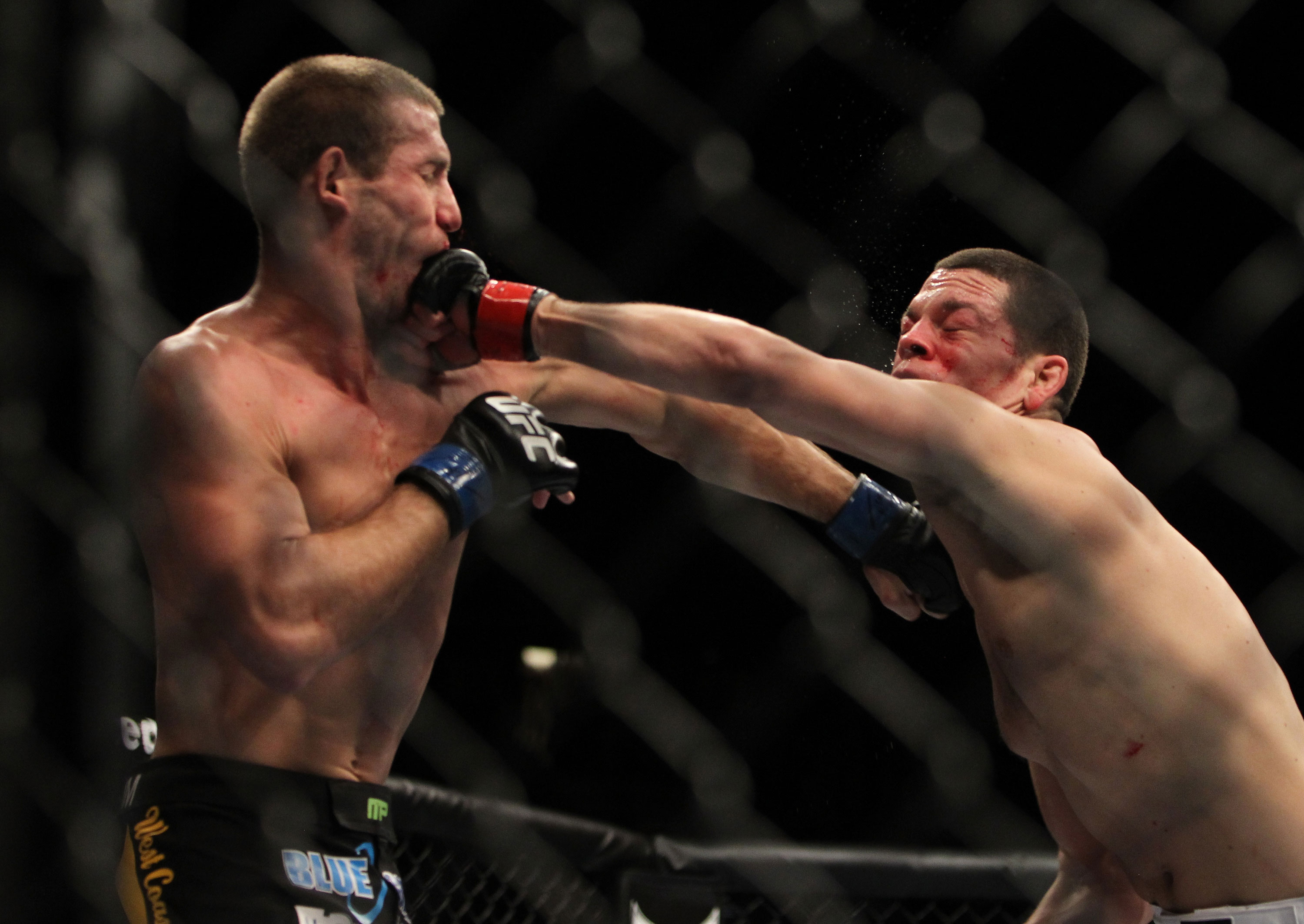 LAS VEGAS, NV - DECEMBER 30: Donald Cerrone (left) and Nate Diaz (right) exchange punches during the UFC 141 event at the MGM Grand Garden Arena on December 30, 2011 in Las Vegas, Nevada. (Photo by Josh Hedges/Zuffa LLC/Zuffa LLC via Getty Images) *** Local Caption *** Donald Cerrone; Nate Diaz