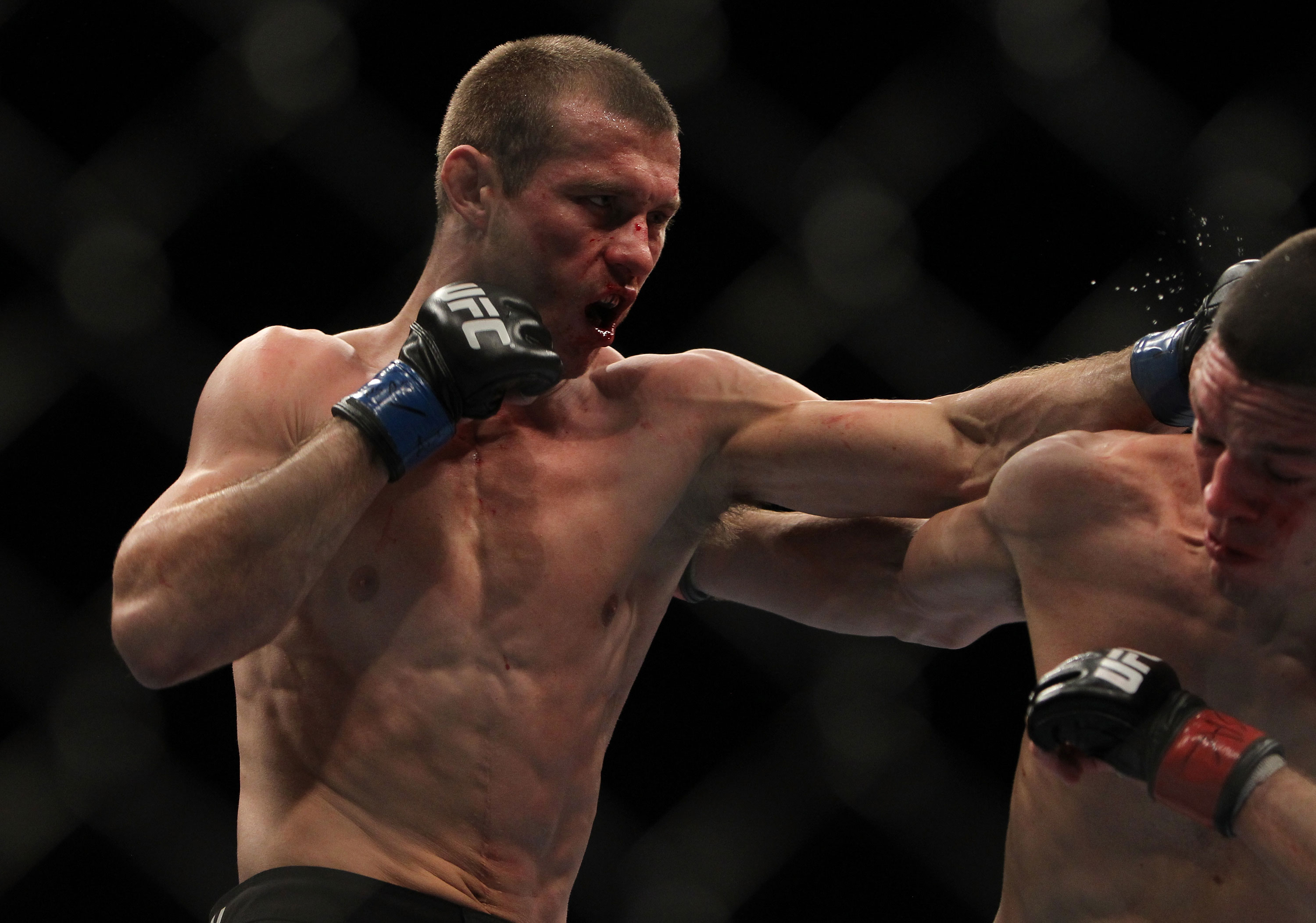 LAS VEGAS, NV - DECEMBER 30: Donald Cerrone (left) punches Nate Diaz during the UFC 141 event at the MGM Grand Garden Arena on December 30, 2011 in Las Vegas, Nevada. (Photo by Josh Hedges/Zuffa LLC/Zuffa LLC via Getty Images) *** Local Caption *** Donald Cerrone; Nate Diaz