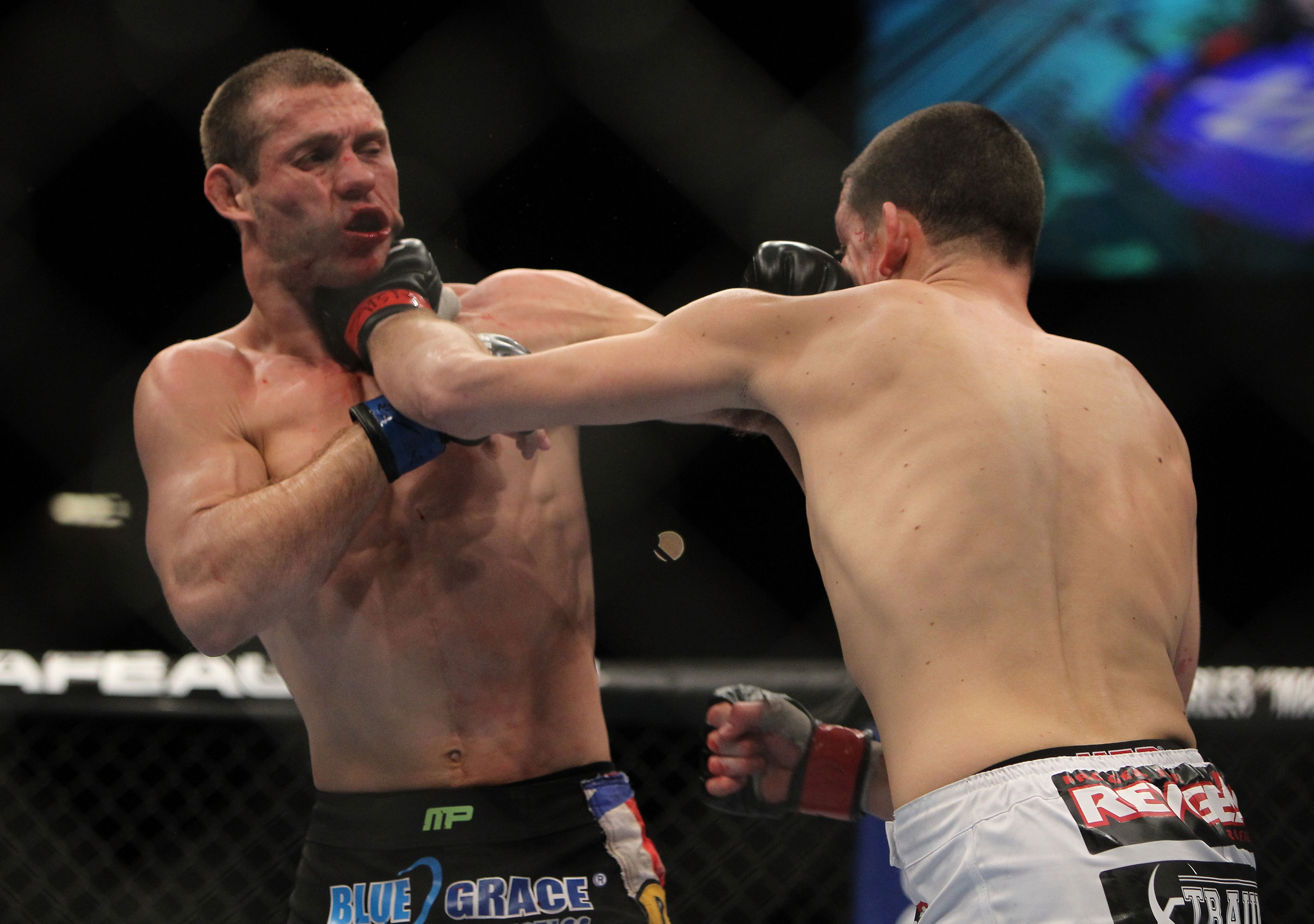 LAS VEGAS, NV - DECEMBER 30: Nate Diaz (right) punches Donald Cerrone (left) during the UFC 141 event at the MGM Grand Garden Arena on December 30, 2011 in Las Vegas, Nevada. (Photo by Josh Hedges/Zuffa LLC/Zuffa LLC via Getty Images) *** Local Caption *** Nate Diaz; Donald Cerrone