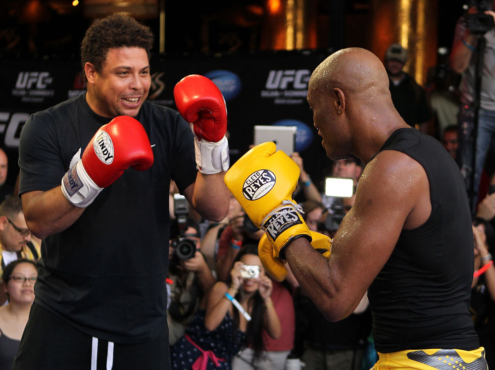 LAS VEGAS, NV - JULY 5: (R-L) UFC Middleweight Champion Anderson Silva spars with Brazilian soccer legend Ronaldo during the UFC 148 Open Workouts inside XS nightclub at the Encore on July 5, 2012 in Las Vegas, Nevada. (Photo by Josh Hedges/Zuffa LLC/Zuffa LLC via Getty Images)