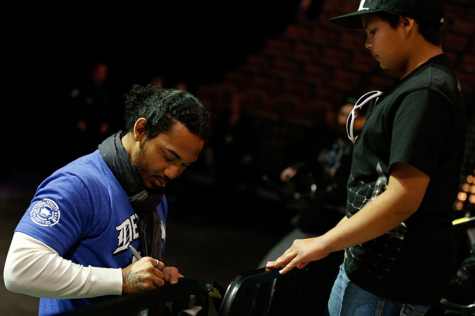 LAS VEGAS, NV - FEBRUARY 01:  UFC lightweight champion Benson Henderson signs an autograph for a young fan during a Q&A session before the UFC 156 weigh-in on February 1, 2013 at Mandalay Bay Events Center in Las Vegas, Nevada.  (Photo by Josh Hedges/Zuffa LLC/Zuffa LLC via Getty Images)