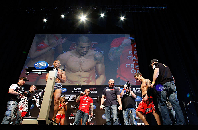 LAS VEGAS, NV - FEBRUARY 01:  Jose Aldo weighs in as opponent Frankie Edgar looks on during the UFC 156 weigh-in on February 1, 2013 at Mandalay Bay Events Center in Las Vegas, Nevada.  (Photo by Josh Hedges/Zuffa LLC/Zuffa LLC via Getty Images)