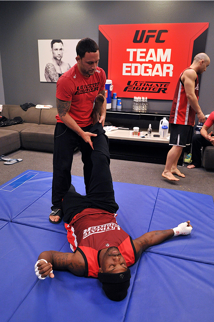 LAS VEGAS, NV - OCTOBER 29: (L-R) Coach Frankie Edgar stretches his fighter Todd Monaghan before he faces Team Penn fighter Daniel Spohn in their preliminary fight during filming of season nineteen of The Ultimate Fighter on October 29, 2013 in Las Vegas, Nevada. (Photo by Jeff Bottari/Zuffa LLC/Zuffa LLC via Getty Images) *** Local Caption *** Frankie Edgar; Todd Monaghan