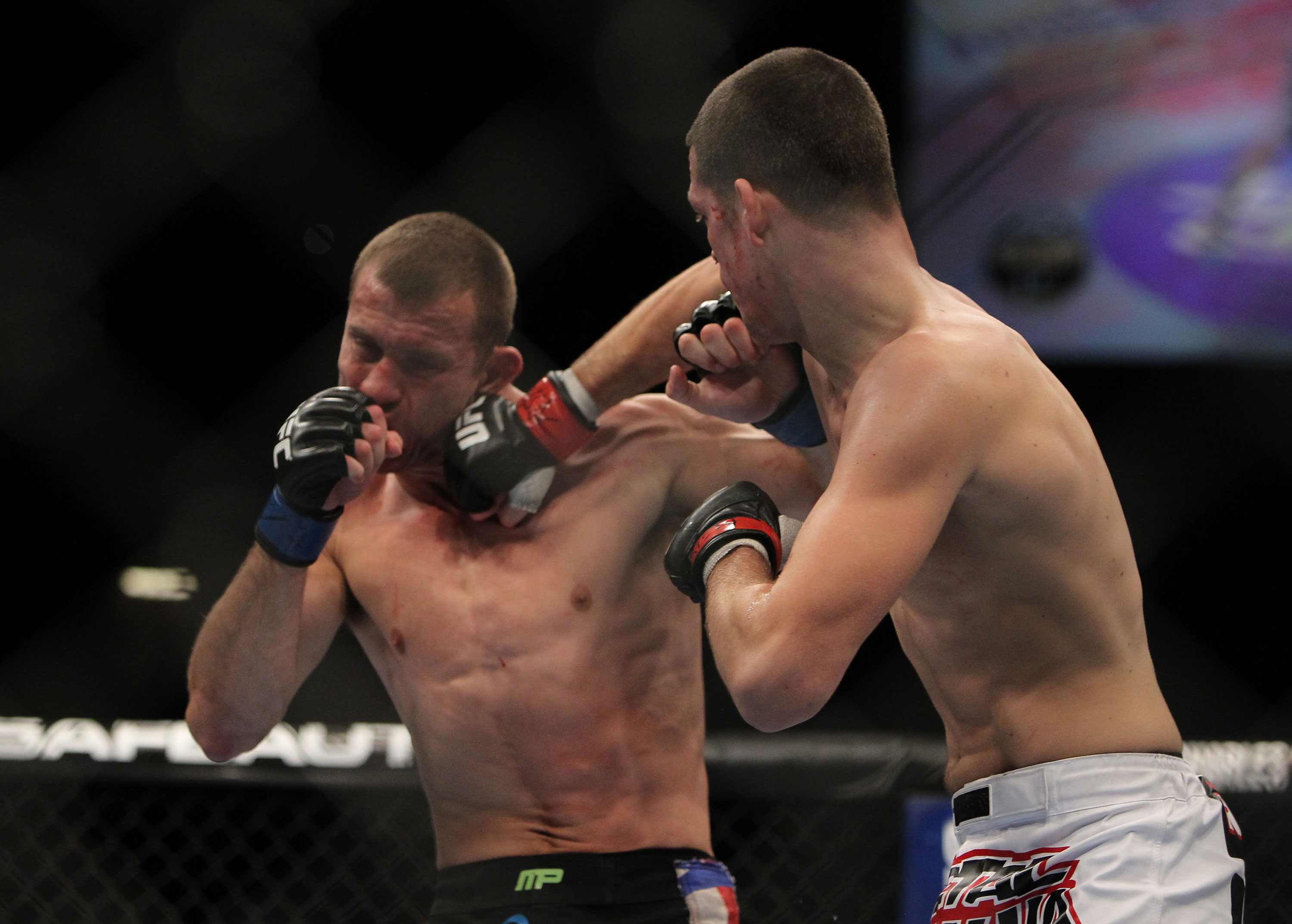 LAS VEGAS, NV - DECEMBER 30: Nate Diaz (right) punches Donald Cerrone (left) during the UFC 141 event at the MGM Grand Garden Arena on December 30, 2011 in Las Vegas, Nevada. (Photo by Josh Hedges/Zuffa LLC/Zuffa LLC via Getty Images) *** Local Caption *** Nate Diaz; Donald Cerrone