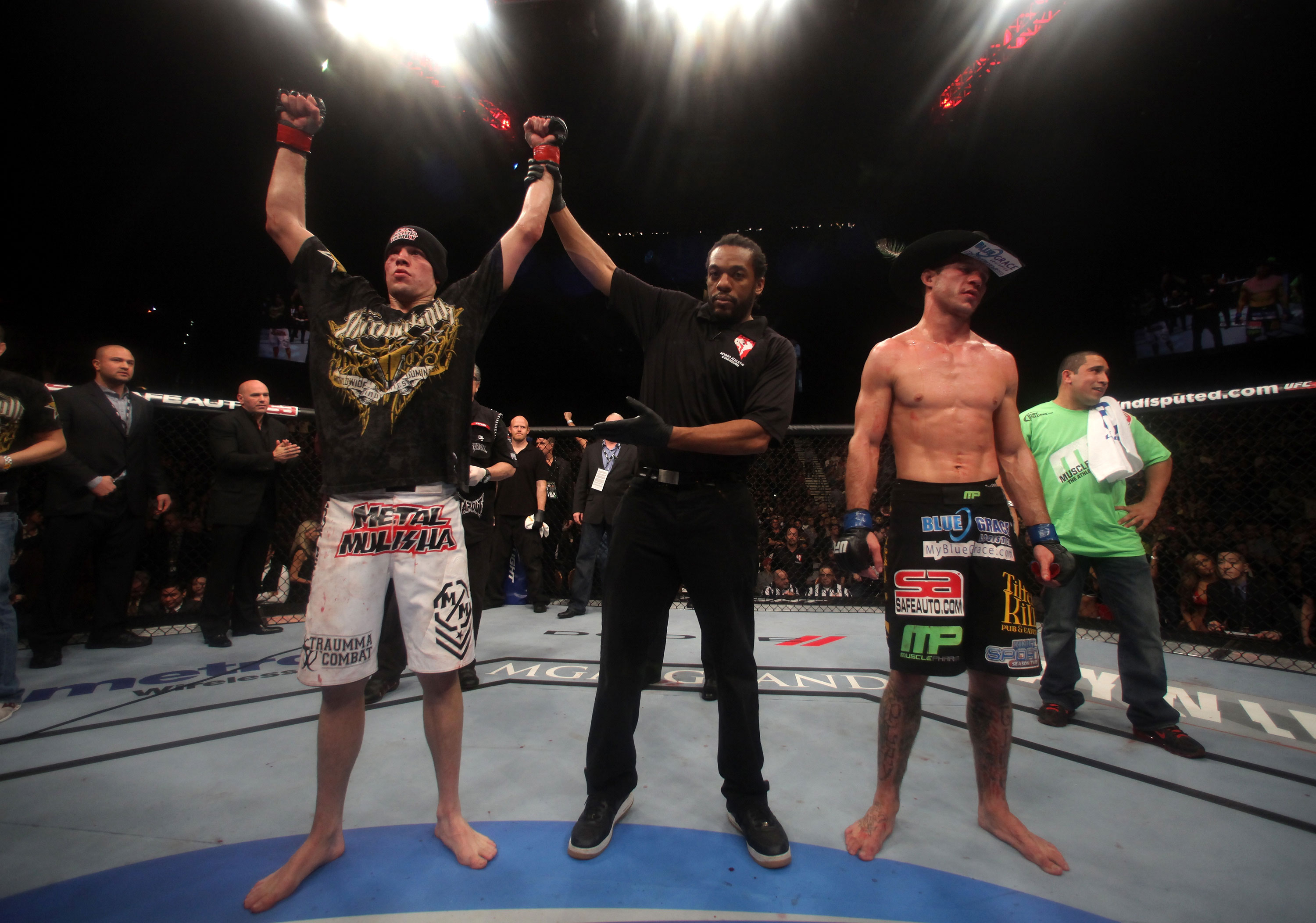 LAS VEGAS, NV - DECEMBER 30: Nate Diaz (left) is declared the winner in his fight with Donald Cerrone (black shorts) during the UFC 141 event at the MGM Grand Garden Arena on December 30, 2011 in Las Vegas, Nevada. (Photo by Donald Miralle/Zuffa LLC/Zuffa LLC via Getty Images) *** Local Caption *** Nate Diaz; Donald Cerrone