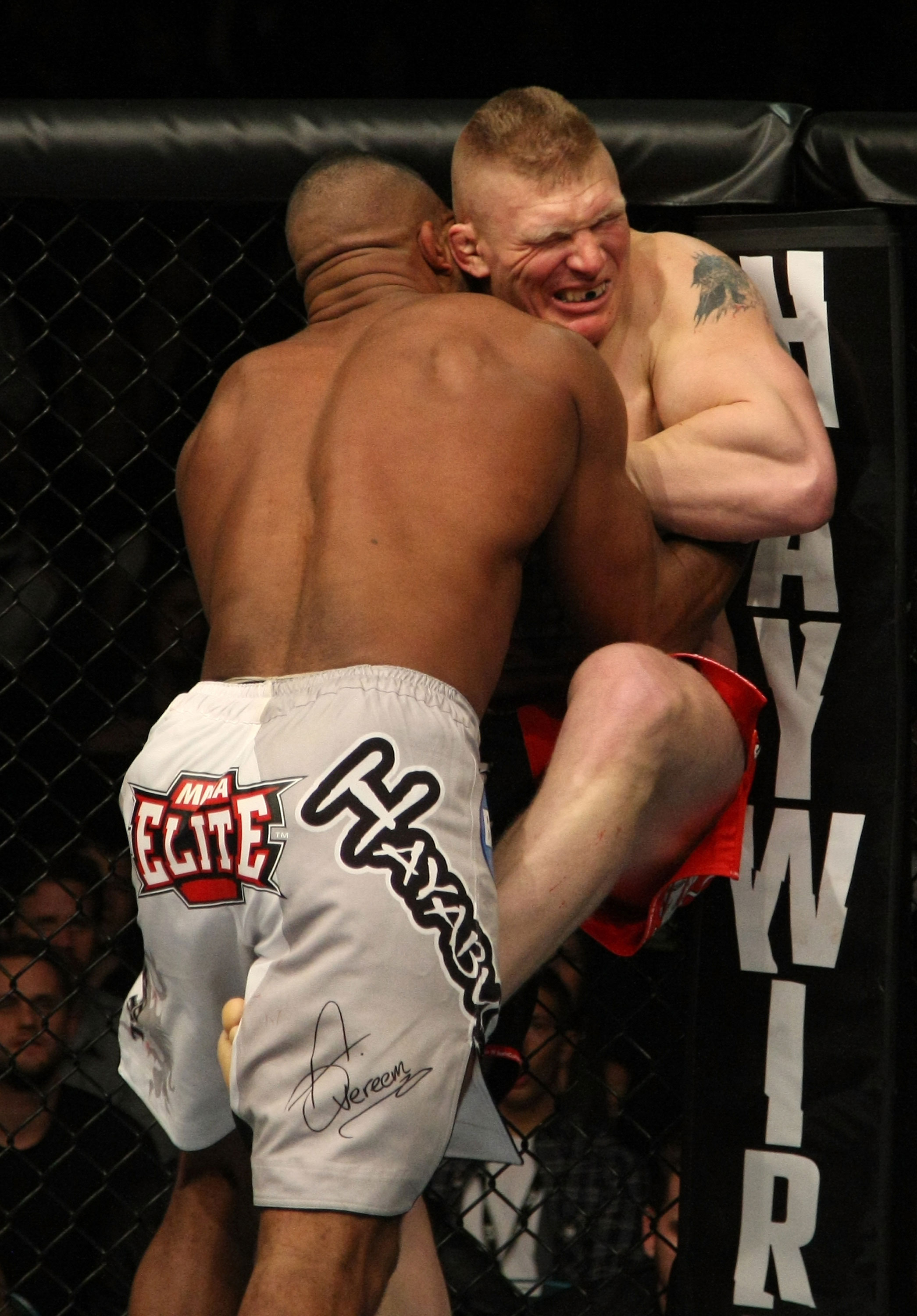 LAS VEGAS, NV - DECEMBER 30: Alistair Overeem (white shorts) and Brock Lesnar (red shorts) struggle against the Octagon fence during the UFC 141 event at the MGM Grand Garden Arena on December 30, 2011 in Las Vegas, Nevada. (Photo by Donald Miralle/Zuffa LLC/Zuffa LLC via Getty Images) *** Local Caption *** Alistair Overeem; Brock Lesnar