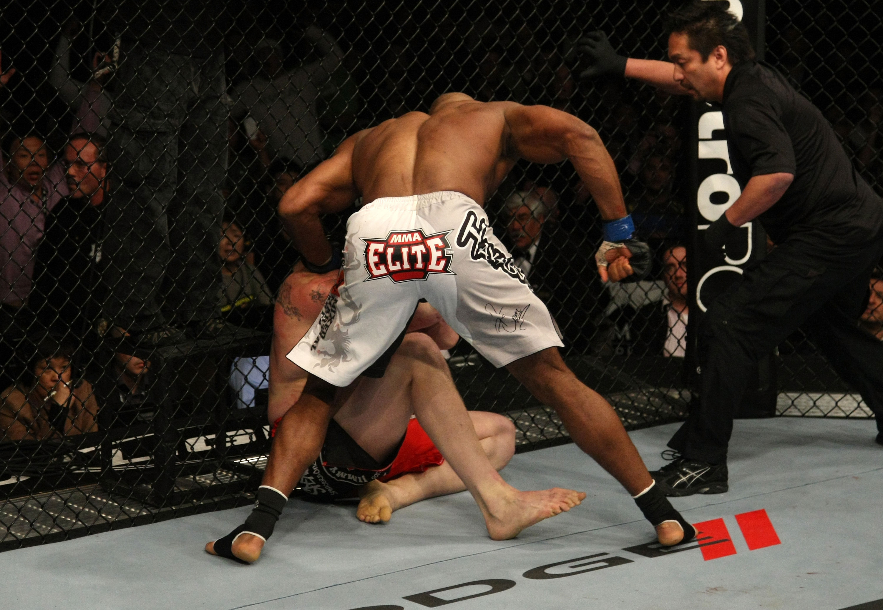 LAS VEGAS, NV - DECEMBER 30: Alistair Overeem (white shorts) punches Brock Lesnar during the UFC 141 event at the MGM Grand Garden Arena on December 30, 2011 in Las Vegas, Nevada. (Photo by Donald Miralle/Zuffa LLC/Zuffa LLC via Getty Images) *** Local Caption *** Alistair Overeem
