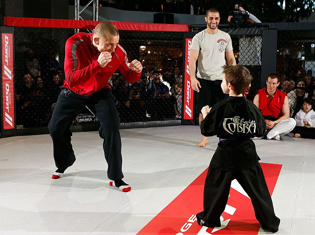 MONTREAL, QC - MARCH 13: UFC welterweight champion Georges St-Pierre (L) spars with students of the Sunfuki Karate school during the UFC 158 open workouts at Complexe Desjardins on March 13, 2013 in Montreal, Quebec, Canada. (Photo by Josh Hedges/Zuffa LLC/Zuffa LLC via Getty Images)