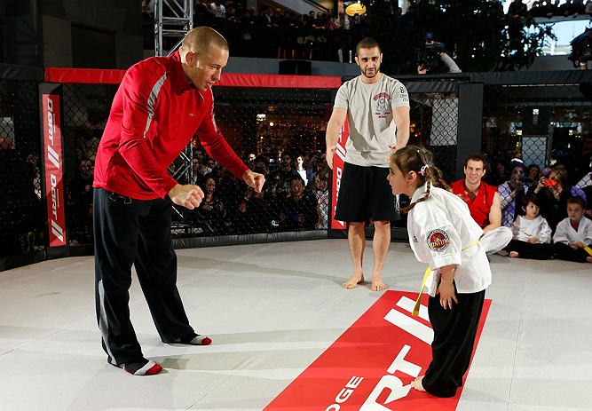 MONTREAL, QC - MARCH 13: UFC welterweight champion Georges St-Pierre (L) spars with students of the Sunfuki Karate school during the UFC 158 open workouts at Complexe Desjardins on March 13, 2013 in Montreal, Quebec, Canada. (Photo by Josh Hedges/Zuffa LLC/Zuffa LLC via Getty Images)