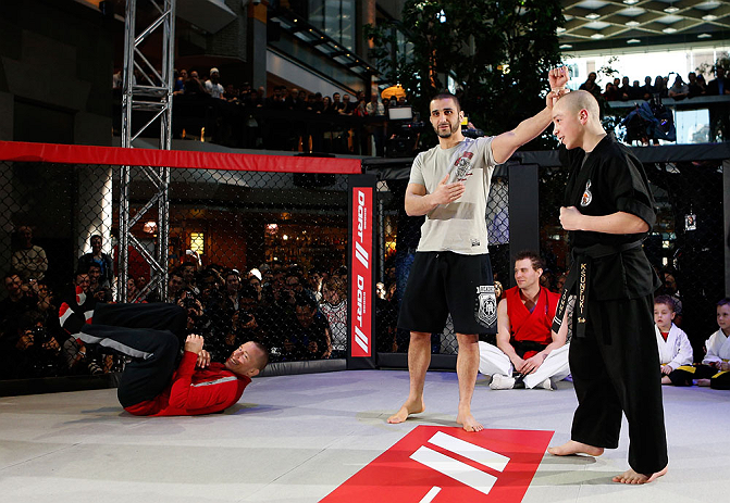 MONTREAL, QC - MARCH 13: UFC welterweight champion Georges St-Pierre (L) spars with students of the Sunfuki Karate school during the UFC 158 open workouts at Complexe Desjardins on March 13, 2013 in Montreal, Quebec, Canada. (Photo by Josh Hedges/Zuffa LLC/Zuffa LLC via Getty Images)