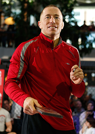 MONTREAL, QC - MARCH 13: UFC welterweight champion Georges St-Pierre signs autographs for fans in attendance during the UFC 158 open workouts at Complexe Desjardins on March 13, 2013 in Montreal, Quebec, Canada. (Photo by Josh Hedges/Zuffa LLC/Zuffa LLC via Getty Images)