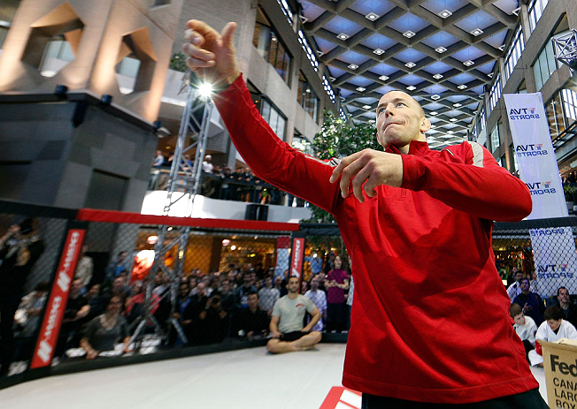 MONTREAL, QC - MARCH 13: UFC welterweight champion Georges St-Pierre tosses autographed DVD's into the crowd during the UFC 158 open workouts at Complexe Desjardins on March 13, 2013 in Montreal, Quebec, Canada. (Photo by Josh Hedges/Zuffa LLC/Zuffa LLC via Getty Images)