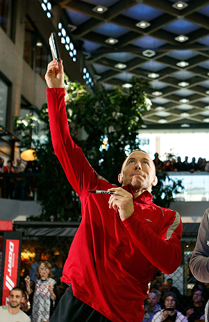 MONTREAL, QC - MARCH 13: UFC welterweight champion Georges St-Pierre tosses autographed DVD's into the crowd during the UFC 158 open workouts at Complexe Desjardins on March 13, 2013 in Montreal, Quebec, Canada. (Photo by Josh Hedges/Zuffa LLC/Zuffa LLC via Getty Images)