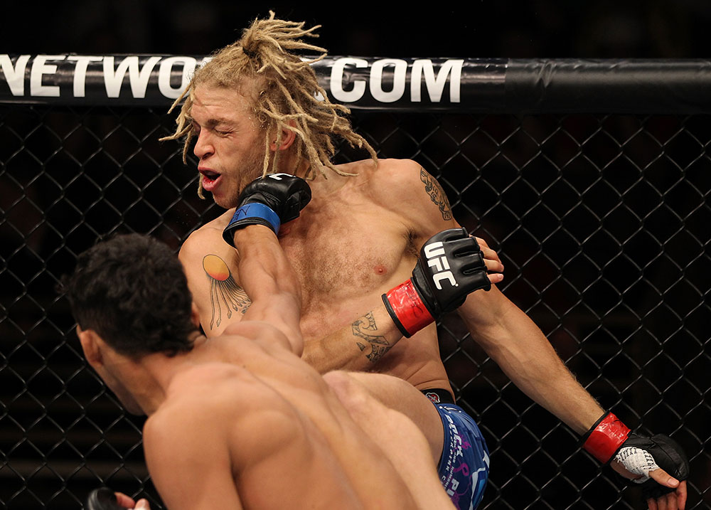LAS VEGAS, NV - JUNE 01: Charles Oliveira (bottom) punches Jonathan Brookins in a Featherweight bout during The Ultimate Fighter Live Finale at the Pearl Theater at the Palms Casino Resort on June 1, 2012 in Las Vegas, Nevada. (Photo by Josh Hedges/Zuffa LLC/Zuffa LLC via Getty Images) *** Local Caption *** Jonathan Brookins; Charles Oliveira