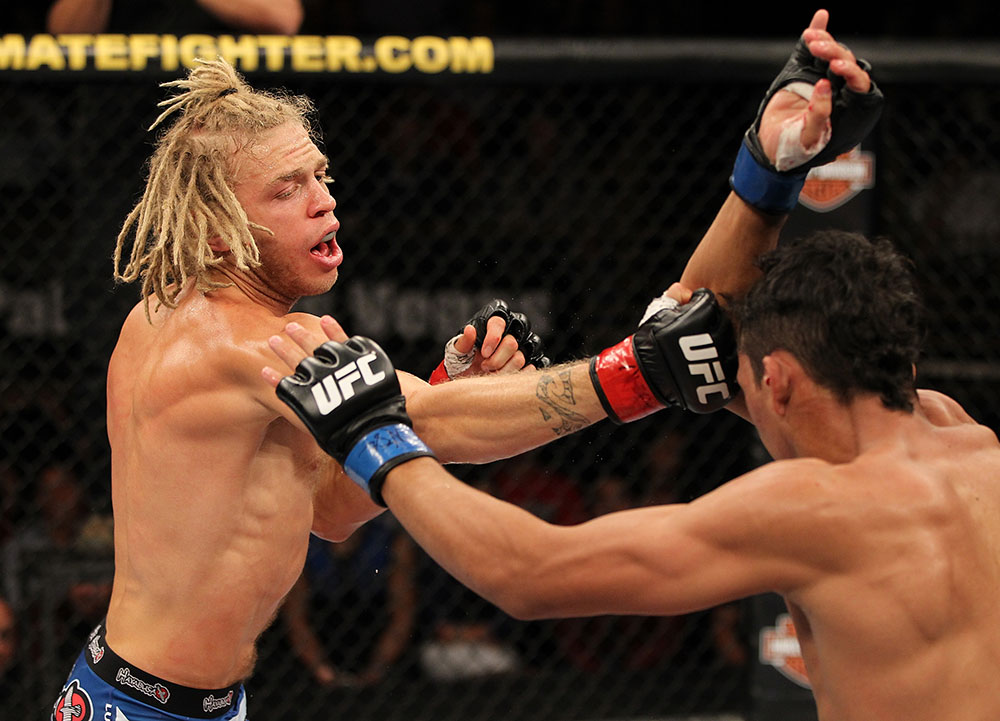 LAS VEGAS, NV - JUNE 01: (L-R) Jonathan Brookins punches Charles Oliveira in a Featherweight bout during The Ultimate Fighter Live Finale at the Pearl Theater at the Palms Casino Resort on June 1, 2012 in Las Vegas, Nevada. (Photo by Josh Hedges/Zuffa LLC/Zuffa LLC via Getty Images) *** Local Caption *** Jonathan Brookins; Charles Oliveira