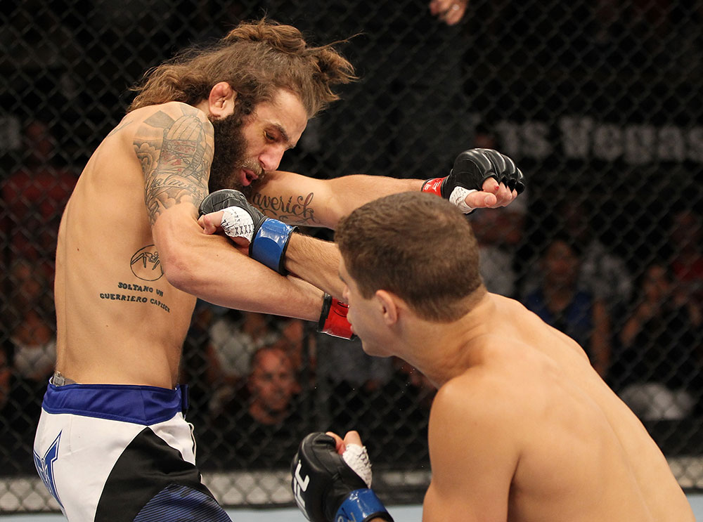 LAS VEGAS, NV - JUNE 01: (R-L) Al Iaquinta punches Michael Chiesa in a Lightweight bout during The Ultimate Fighter Live Finale at the Pearl Theater at the Palms Casino Resort on June 1, 2012 in Las Vegas, Nevada. (Photo by Josh Hedges/Zuffa LLC/Zuffa LLC via Getty Images) *** Local Caption *** Al Iaquinta; Michael Chiesa