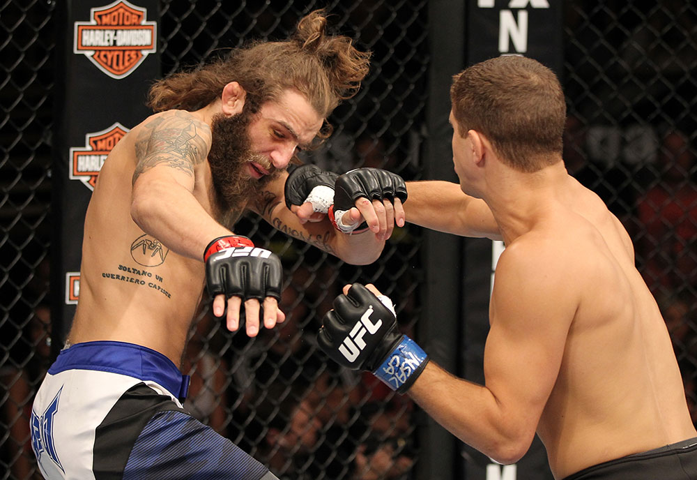 LAS VEGAS, NV - JUNE 01: (R-L) Al Iaquinta punches Michael Chiesa in a Lightweight bout during The Ultimate Fighter Live Finale at the Pearl Theater at the Palms Casino Resort on June 1, 2012 in Las Vegas, Nevada. (Photo by Josh Hedges/Zuffa LLC/Zuffa LLC via Getty Images) *** Local Caption *** Al Iaquinta; Michael Chiesa