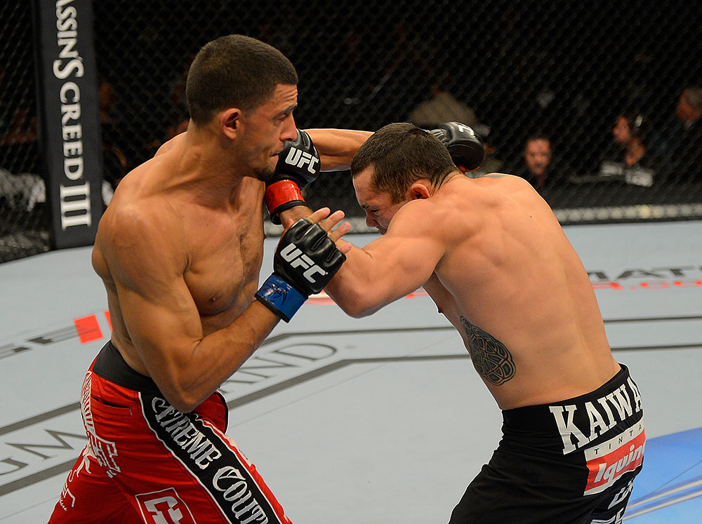 LAS VEGAS, NV - JULY 7:   (L-R) Yoislandy Izquierdo and Rafaello Oliveira exchange punches during their lightweight bout at UFC 148 inside MGM Grand Garden Arena on July 7, 2012 in Las Vegas, Nevada.  (Photo by Donald Miralle/Zuffa LLC/Zuffa LLC via Getty Images)  *** Local Caption *** Yoislandy Izquierdo; Rafaello Oliveira