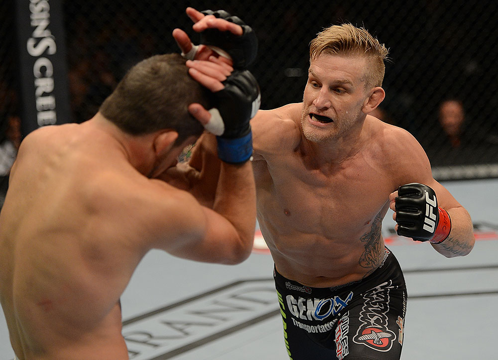 LAS VEGAS, NV - JULY 7:   (R-L) John Alessio punches Shane Roller during their lightweight bout at UFC 148 inside MGM Grand Garden Arena on July 7, 2012 in Las Vegas, Nevada.  (Photo by Donald Miralle/Zuffa LLC/Zuffa LLC via Getty Images)  *** Local Caption *** John Alessio; Shane Roller