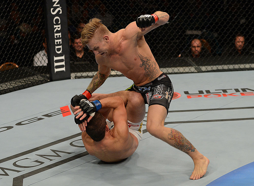 LAS VEGAS, NV - JULY 7:   John Alessio (top) punches Shane Roller during their lightweight bout at UFC 148 inside MGM Grand Garden Arena on July 7, 2012 in Las Vegas, Nevada.  (Photo by Donald Miralle/Zuffa LLC/Zuffa LLC via Getty Images)  *** Local Caption *** John Alessio; Shane Roller