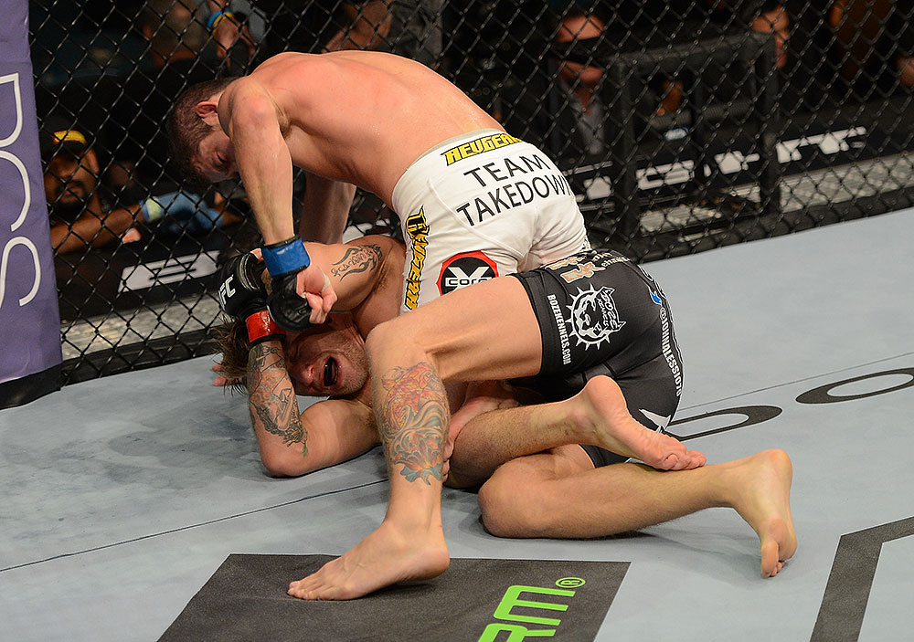 LAS VEGAS, NV - JULY 7:   Shane Roller (top) punches John Alessio during their lightweight bout at UFC 148 inside MGM Grand Garden Arena on July 7, 2012 in Las Vegas, Nevada.  (Photo by Donald Miralle/Zuffa LLC/Zuffa LLC via Getty Images)  *** Local Caption *** John Alessio; Shane Roller