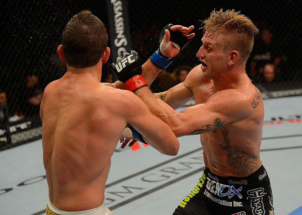 LAS VEGAS, NV - JULY 7:   (R-L) John Alessio punches Shane Roller during their lightweight bout at UFC 148 inside MGM Grand Garden Arena on July 7, 2012 in Las Vegas, Nevada.  (Photo by Donald Miralle/Zuffa LLC/Zuffa LLC via Getty Images)  *** Local Caption *** John Alessio; Shane Roller