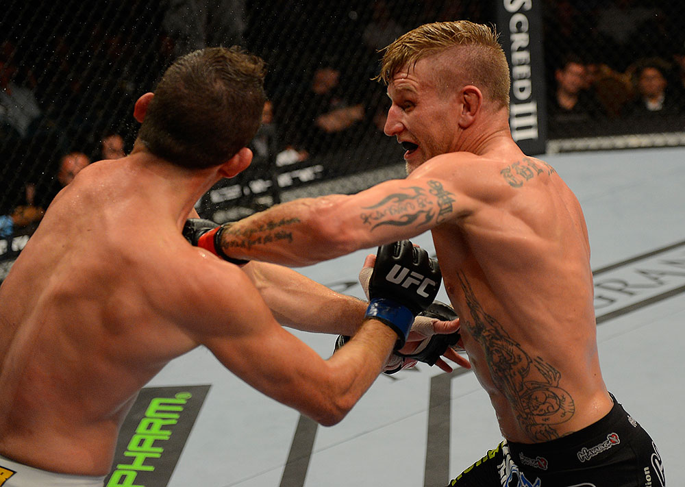 LAS VEGAS, NV - JULY 7:   (R-L) John Alessio punches Shane Roller during their lightweight bout at UFC 148 inside MGM Grand Garden Arena on July 7, 2012 in Las Vegas, Nevada.  (Photo by Donald Miralle/Zuffa LLC/Zuffa LLC via Getty Images)  *** Local Caption *** John Alessio; Shane Roller