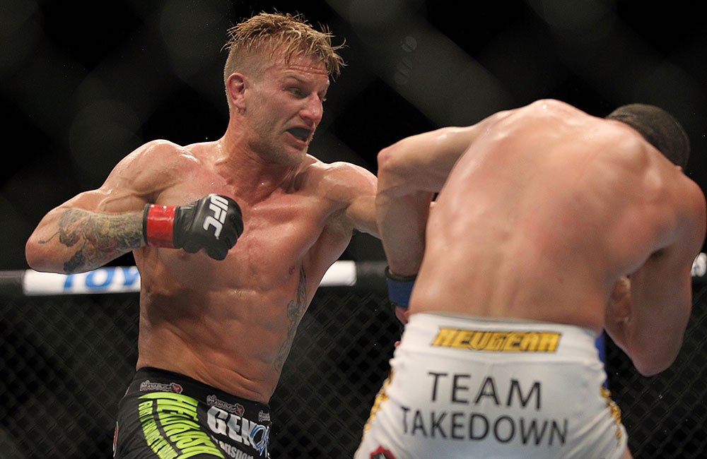 LAS VEGAS, NV - JULY 7:   (L-R) John Alessio punches Shane Roller during their lightweight bout at UFC 148 inside MGM Grand Garden Arena on July 7, 2012 in Las Vegas, Nevada.  (Photo by Josh Hedges/Zuffa LLC/Zuffa LLC via Getty Images)  *** Local Caption *** John Alessio; Shane Roller