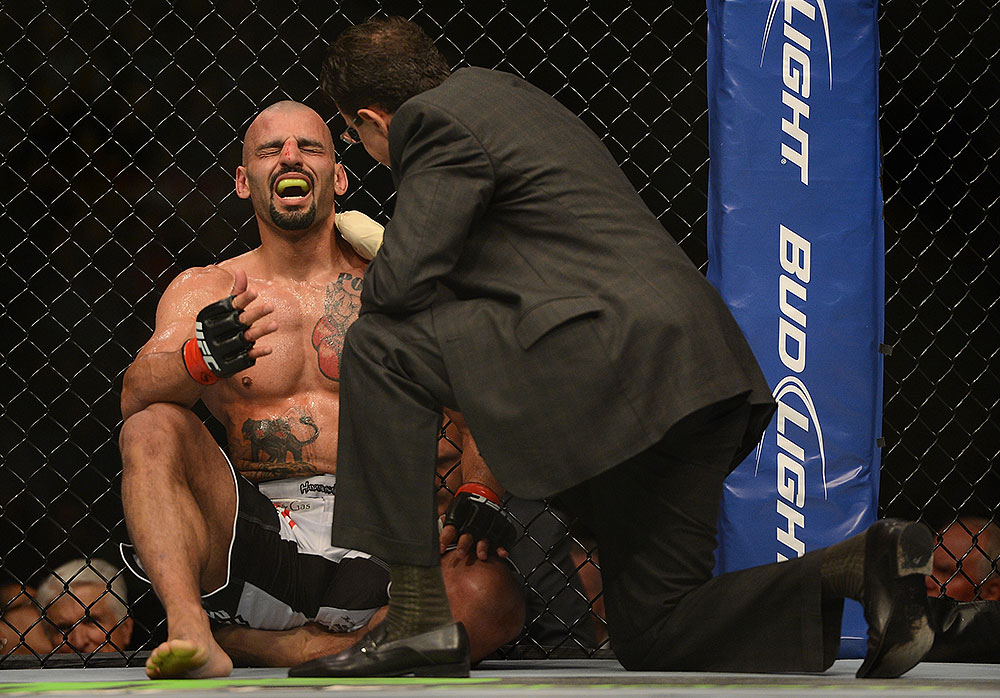 LAS VEGAS, NV - JULY 7:   Costa Philippou (left) is inspected by a doctor during their middleweight bout at UFC 148 inside MGM Grand Garden Arena on July 7, 2012 in Las Vegas, Nevada.  (Photo by Donald Miralle/Zuffa LLC/Zuffa LLC via Getty Images)  *** Local Caption *** Constantinos Philippou; Riki Fukuda