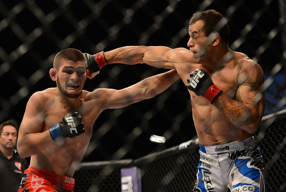 LAS VEGAS, NV - JULY 7:   (R-L) Gleison Tibau punches Khabib Nurmagomedov during their lightweight bout at UFC 148 inside MGM Grand Garden Arena on July 7, 2012 in Las Vegas, Nevada.  (Photo by Donald Miralle/Zuffa LLC/Zuffa LLC via Getty Images)  *** Local Caption *** Khabib Nurmagomedov; Gleison Tibau