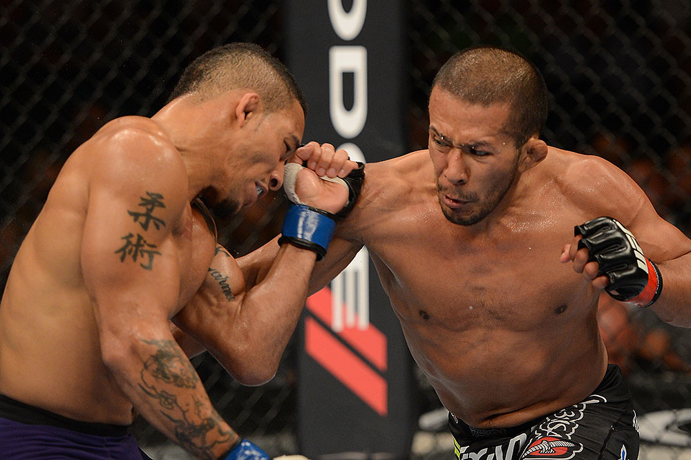LAS VEGAS, NV - JULY 7:   Ivan Menjivar (right) punches Mike Easton during their bantamweight bout at UFC 148 inside MGM Grand Garden Arena on July 7, 2012 in Las Vegas, Nevada.  (Photo by Donald Miralle/Zuffa LLC/Zuffa LLC via Getty Images)  *** Local Caption *** Ivan Menjivar; Mike Easton