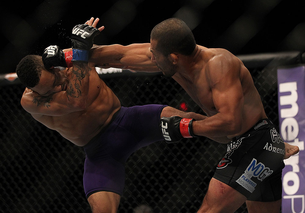 LAS VEGAS, NV - JULY 7:   (R-L) Ivan Menjivar punches Mike Easton during their bantamweight bout at UFC 148 inside MGM Grand Garden Arena on July 7, 2012 in Las Vegas, Nevada.  (Photo by Josh Hedges/Zuffa LLC/Zuffa LLC via Getty Images)  *** Local Caption *** Ivan Menjivar; Mike Easton