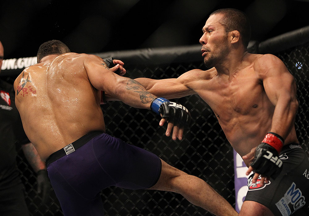 LAS VEGAS, NV - JULY 7:   (R-L) Ivan Menjivar punches Mike Easton during their bantamweight bout at UFC 148 inside MGM Grand Garden Arena on July 7, 2012 in Las Vegas, Nevada.  (Photo by Josh Hedges/Zuffa LLC/Zuffa LLC via Getty Images)  *** Local Caption *** Ivan Menjivar; Mike Easton