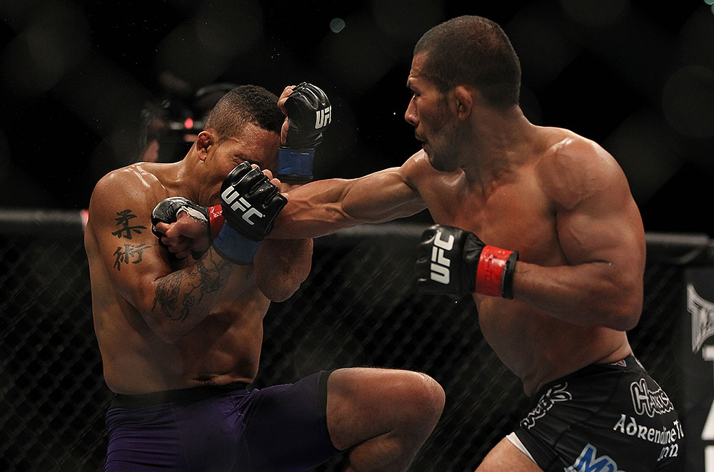 LAS VEGAS, NV - JULY 7:   (R-L) Ivan Menjivar punches Mike Easton during their bantamweight bout at UFC 148 inside MGM Grand Garden Arena on July 7, 2012 in Las Vegas, Nevada.  (Photo by Josh Hedges/Zuffa LLC/Zuffa LLC via Getty Images)  *** Local Caption *** Ivan Menjivar; Mike Easton