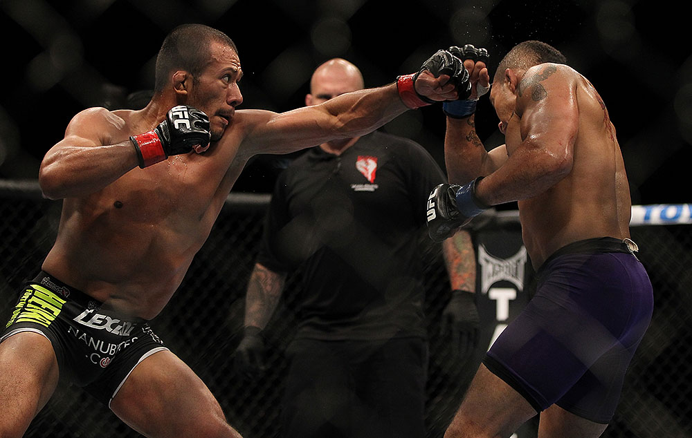 LAS VEGAS, NV - JULY 7:   (L-R) Ivan Menjivar punches Mike Easton during their bantamweight bout at UFC 148 inside MGM Grand Garden Arena on July 7, 2012 in Las Vegas, Nevada.  (Photo by Josh Hedges/Zuffa LLC/Zuffa LLC via Getty Images)  *** Local Caption *** Ivan Menjivar; Mike Easton