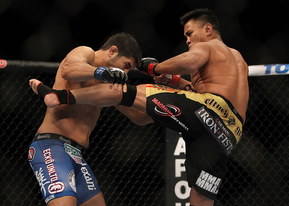 LAS VEGAS, NV - JULY 7:   (R-L) Cung Le kicks Patrick Cote during their middleweight bout at UFC 148 inside MGM Grand Garden Arena on July 7, 2012 in Las Vegas, Nevada.  (Photo by Josh Hedges/Zuffa LLC/Zuffa LLC via Getty Images)  *** Local Caption *** Cung Le; Patrick Cote