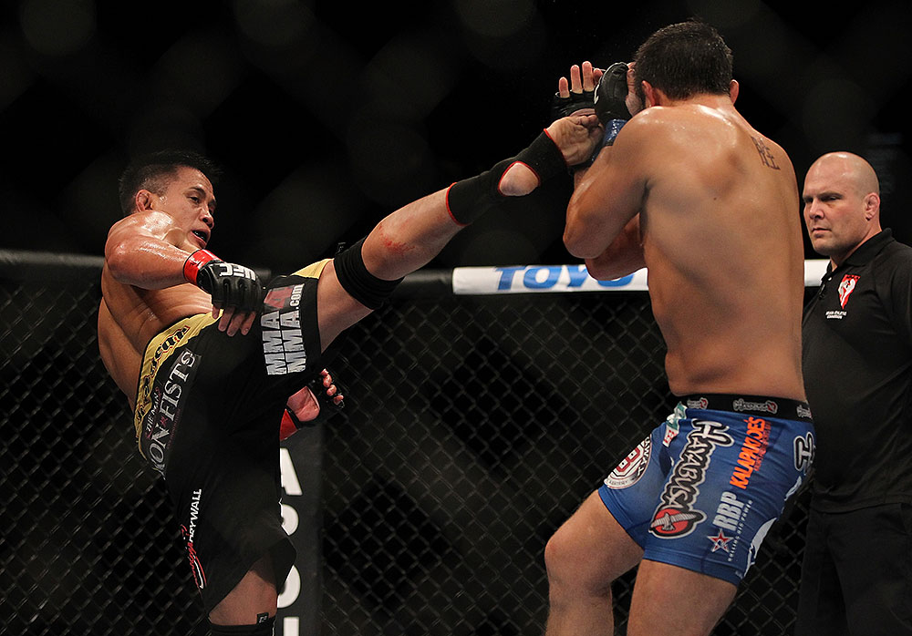 LAS VEGAS, NV - JULY 7:   Cung Le (left) kicks Patrick Cote during their middleweight bout at UFC 148 inside MGM Grand Garden Arena on July 7, 2012 in Las Vegas, Nevada.  (Photo by Josh Hedges/Zuffa LLC/Zuffa LLC via Getty Images)  *** Local Caption *** Cung Le; Patrick Cote