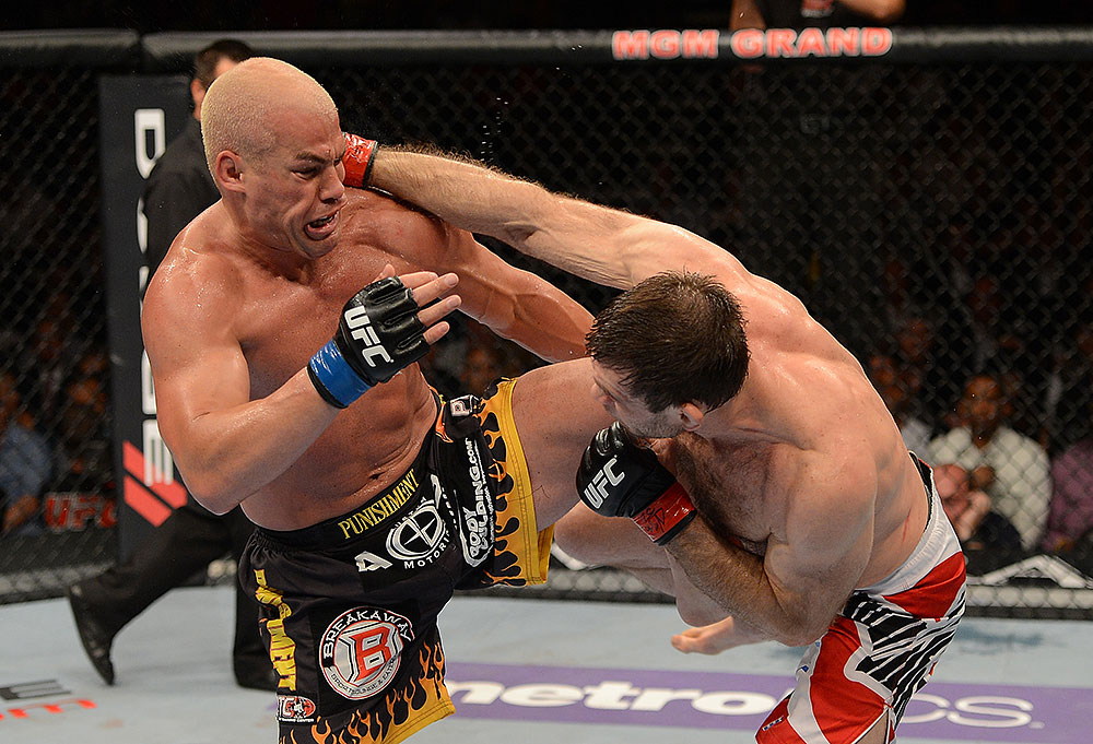 LAS VEGAS, NV - JULY 7:   (R-L) Forrest Griffin punches Tito Ortiz during their light heavyweight bout at UFC 148 inside MGM Grand Garden Arena on July 7, 2012 in Las Vegas, Nevada.  (Photo by Donald Miralle/Zuffa LLC/Zuffa LLC via Getty Images)  *** Local Caption *** Tito Ortiz; Forrest Griffin