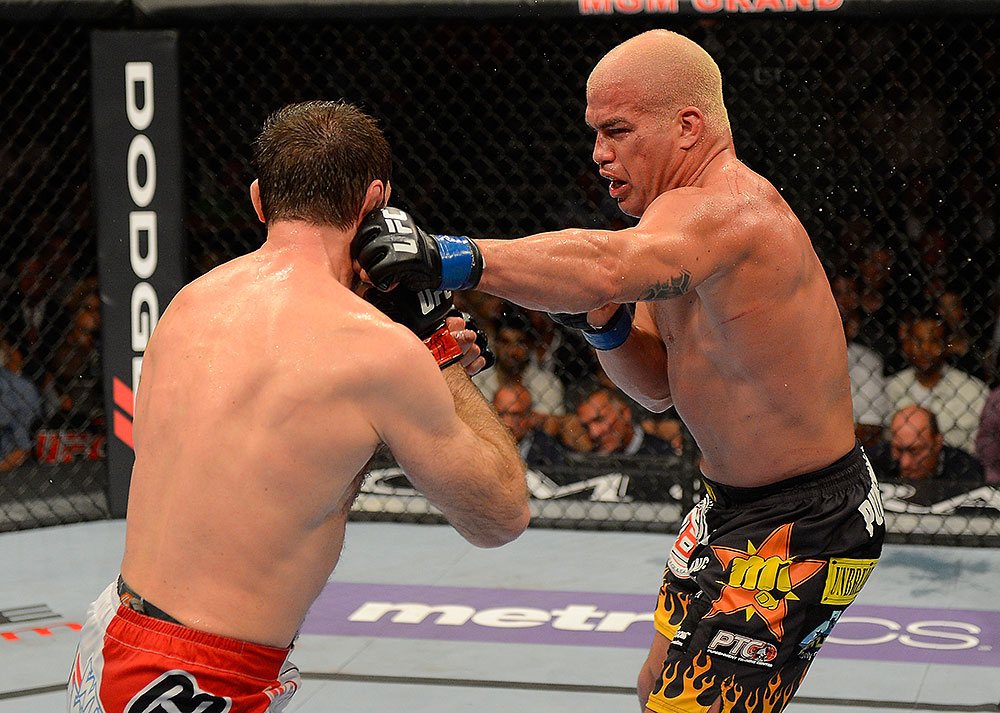 LAS VEGAS, NV - JULY 7:   (R-L) Tito Ortiz punches Forrest Griffin during their light heavyweight bout at UFC 148 inside MGM Grand Garden Arena on July 7, 2012 in Las Vegas, Nevada.  (Photo by Donald Miralle/Zuffa LLC/Zuffa LLC via Getty Images)  *** Local Caption *** Tito Ortiz; Forrest Griffin