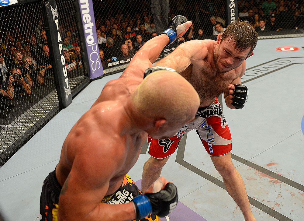 LAS VEGAS, NV - JULY 7:   (R-L) Forrest Griffin punches Tito Ortiz during their light heavyweight bout at UFC 148 inside MGM Grand Garden Arena on July 7, 2012 in Las Vegas, Nevada.  (Photo by Donald Miralle/Zuffa LLC/Zuffa LLC via Getty Images)  *** Local Caption *** Tito Ortiz; Forrest Griffin