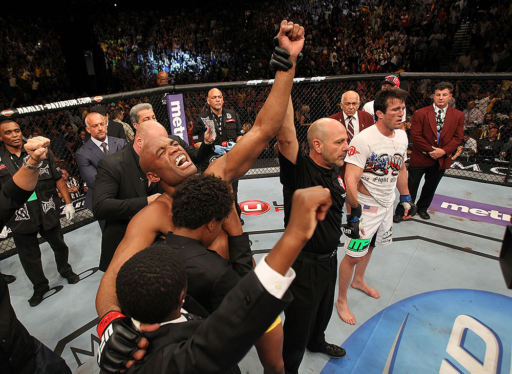 LAS VEGAS, NV - JULY 7:   Anderson Silva (left) reacts to being declared the winner in his fight against Chael Sonnen (white shirt, right) after their UFC middleweight championship bout at UFC 148 inside MGM Grand Garden Arena on July 7, 2012 in Las Vegas, Nevada.  (Photo by Josh Hedges/Zuffa LLC/Zuffa LLC via Getty Images)  *** Local Caption *** Anderson Silva; Chael Sonnen