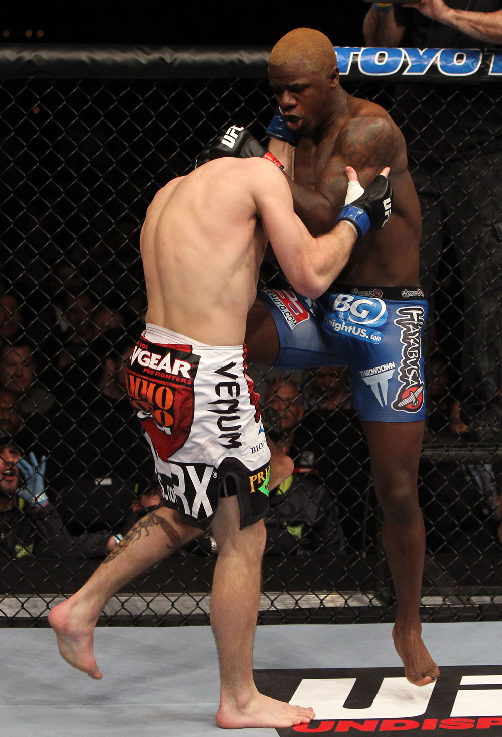 NASHVILLE, TN - JANUARY 20:  (R-L) Melvin Guillard delivers a knee strike against Jim Miller during the UFC on FX event at Bridgestone Arena on January 20, 2012 in Nashville, Tennessee.  (Photo by Josh Hedges/Zuffa LLC/Zuffa LLC via Getty Images)