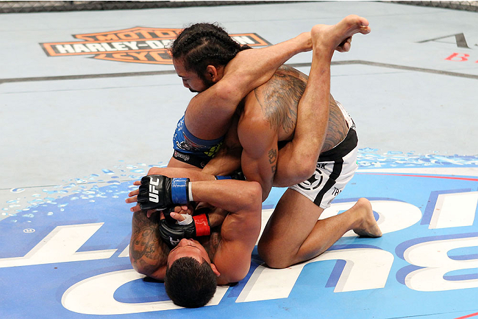 MILWAUKEE, WI - AUGUST 31:  (L-R) Anthony Pettis puts Benson Henderson in an armbar in their UFC lightweight championship bout at BMO Harris Bradley Center on August 31, 2013 in Milwaukee, Wisconsin. (Photo by Ed Mulholland/Zuffa LLC/Zuffa LLC via Getty Images) *** Local Caption *** Benson Henderson; Anthony Pettis