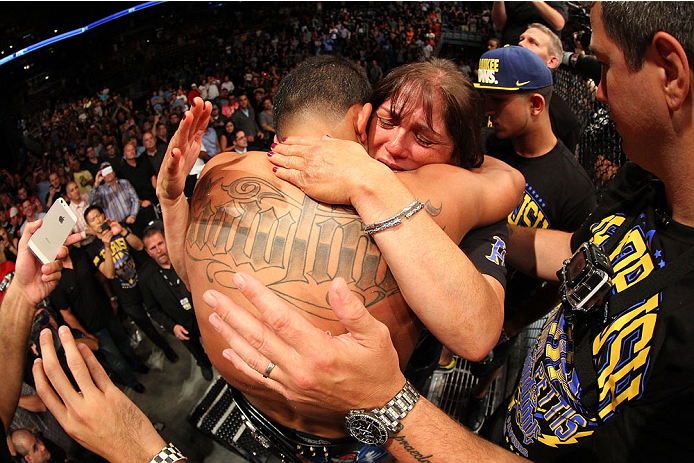 MILWAUKEE, WI - AUGUST 31:  Anthony Pettis celebrates with his mother Annette Garcia after receiving the lightweight championship belt after defeating Benson Henderson in their UFC lightweight championship bout at BMO Harris Bradley Center on August 31, 2013 in Milwaukee, Wisconsin. (Photo by Ed Mulholland/Zuffa LLC/Zuffa LLC via Getty Images) *** Local Caption *** Anthony Pettis; Anette Garcia