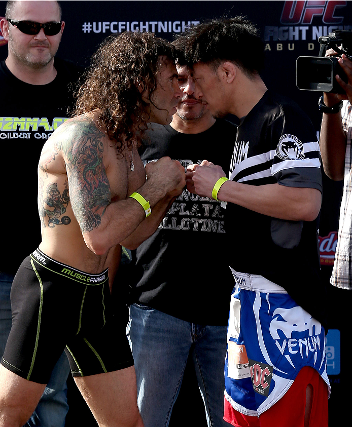 ABU DHABI, UNITED ARAB EMIRATES - APRIL 10:  Clay Guida and Tatsuya Kawajiri of Japan face-off after they weigh-in for UFC Fight Night 39 on April 10, 2014 in Abu Dhabi, United Arab Emirates. UFC Fight Night 39 will take place on April 11 at du Arena featuring Antonio Rodrigo Nogueira and Roy Nelson.  (Photo by Warren Little/Zuffa LLC/Zuffa LLC via Getty Images)