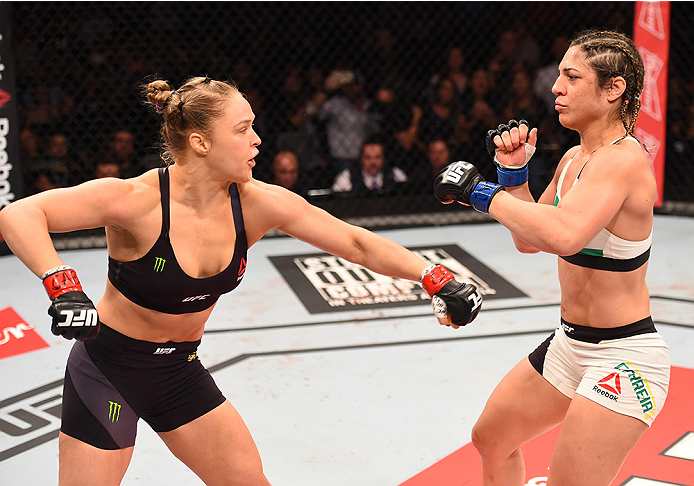 (L-R) Ronda Rousey of the United States throws a punch at Bethe Correia of Brazil in their UFC women's bantamweight championship bout during the UFC 190 event inside HSBC Arena on August 1, 2015 in Rio de Janeiro, Brazil. (Photo by Josh Hedges/Zuffa LLC)