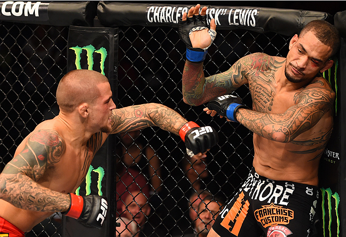 Dustin Poirier punches Yancy Medeiros in their lightweight bout during the UFC event at the Smoothie King Center on June 6, 2015 in New Orleans, Louisiana. (Photo by Josh Hedges/Zuffa LLC)